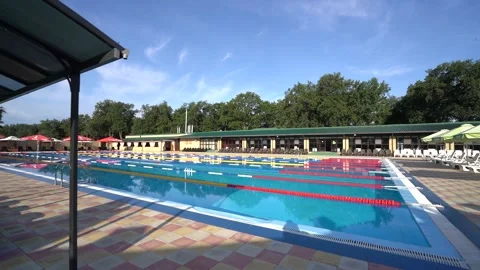 Shooting an empty pool with a steadicam in summer weather blue water Stock Footage 201592734