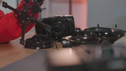 Shooting of equipment for constructing drone. Guy in red hoodie working on Stock Footage 186145317