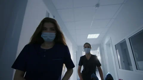 Shooting in the first person. Two nurses carry a patient on a gurney. POV Stock Footage 208001092
