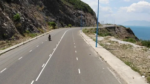 Shooting from a flying camera beautiful road along the sea in Vietnam Stock Footage 100187698