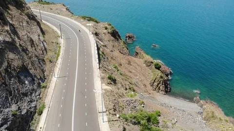 Shooting from a flying camera beautiful road along the sea Video stock 100187780
