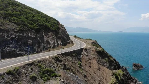 Shooting from a flying camera beautiful road along the sea in Vietnam Stock Footage 100187809