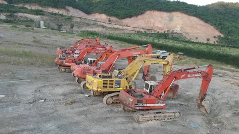 Shooting from a flying camera parking of old excavators from different angles Video stock 115725310