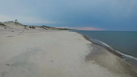 Shooting in the forward motion of the sandy shore washed by oceanic water. Coast Video stock 93789644