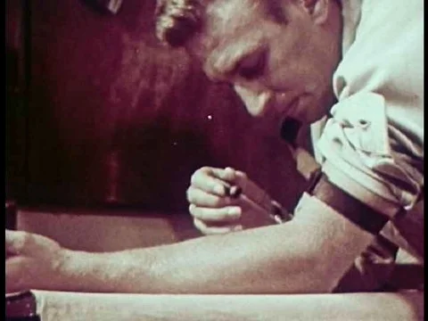 A shooting gallery is introduced as a room where addicts come to share needles 動画素材 74775830