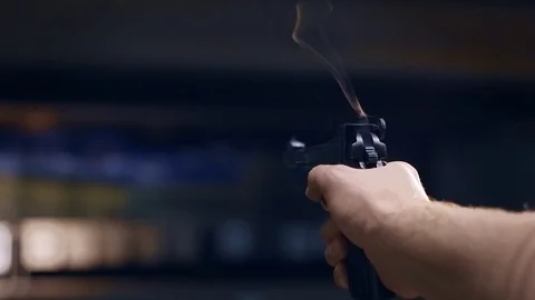 Shooting gallery. A young man preparing the gun and shooting with a firearms. Stock-Footage 117240700