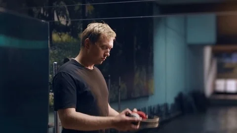 Shooting gallery. A young man preparing the gun and shooting with a firearms. Stock-Footage 117240771