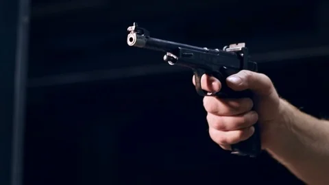 Shooting gallery. A young man preparing the gun and shooting with a firearms. Stock-Footage 117240794