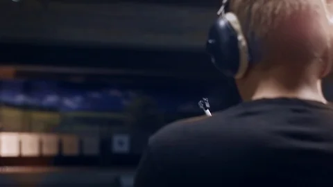 Shooting gallery. A young man preparing the gun and shooting with a firearms. Stock-Footage 117240847
