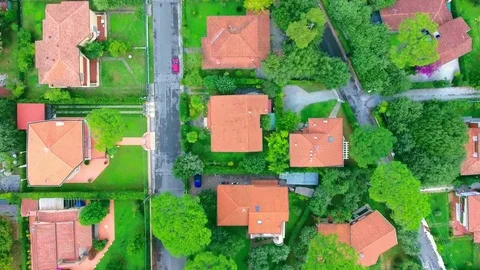 Shooting from a helicopter flight over the streets, houses and lawns of the Stock Footage 73528232