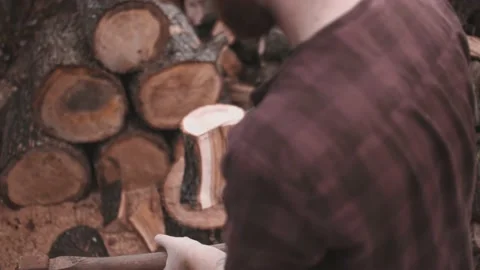 Shooting i slow motion of young smoking guy chop firewood Stock Footage 142108926