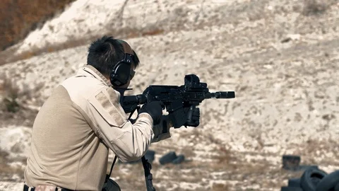 Shooting instructor shoots from an automatic carbine and reloads the store Stock Footage 102662233