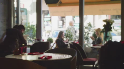 Shooting the interior of a cafe against the backdrop of a city street.  Stock Footage 306657838