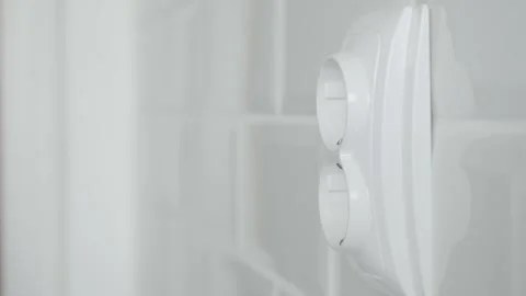 Shooting with a Man Disconnecting a Plug from the Electrical Outlet, Powering Stock Footage 312120112
