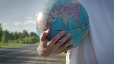 Shooting of man walking with globe in hands Video stock 165199517