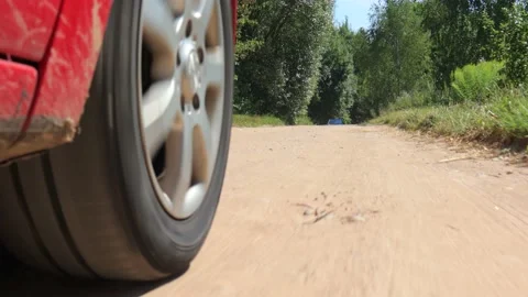 Shooting in motion, view from the wheel, driving a red car over the road Stock Footage