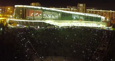 Shooting night event in front of lit stadium. Shooting crowds from quadrocopter. Stock Footage 128997465