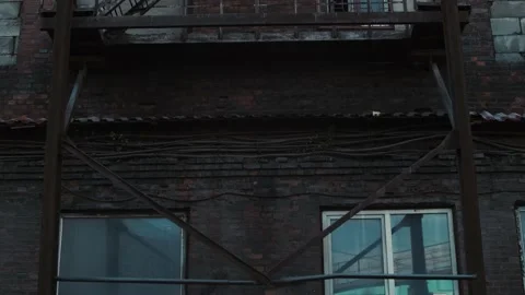 Shooting of an old brick building with windows and iron stairs Stock Footage 156679824
