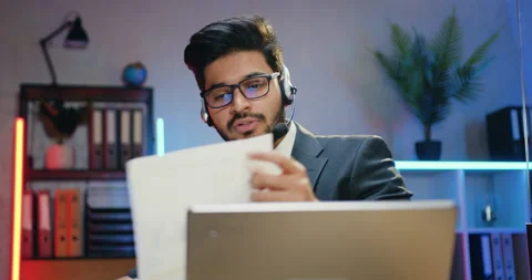 Shooting over computer on handsome confident purposeful modern bearded office Stock Footage 166626567
