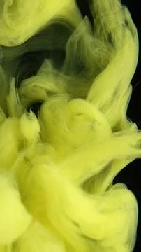 Shooting paint underwater to create patterns with yellow acrylic colors Stock Photos