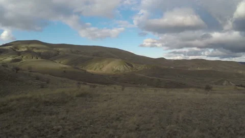 Shooting a panorama of a flying camera over the hillsides and a coastal village Stock Footage 86791692