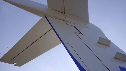 Shooting of a plane's fin and elevators, clean white airplane. Video stock 95048685
