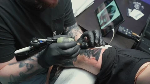 Shooting of professional getting tattoo of snake in studio Stock Footage 123906489