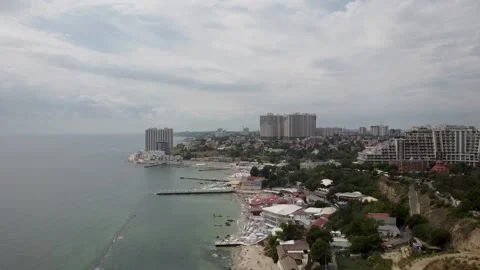 Shooting from a quadcopter view of the beach and the city by the sea Stock Footage 148078901