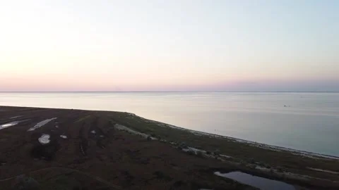 Shooting from a quadcopter view of the sunset on a desert island Stock Footage 148078892
