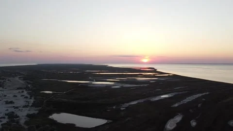 Shooting from a quadcopter view of the sunset on a desert island and sea Stock Footage 148078896