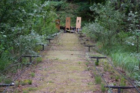 Shooting range in a summer forest under the open sky with targets in the back Stock Photos