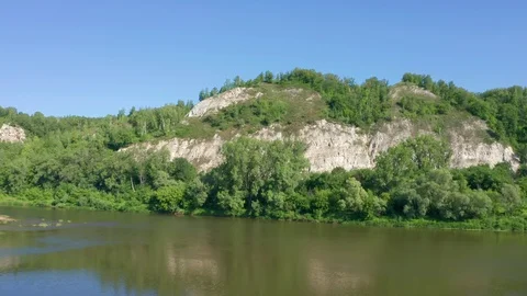 Shooting rocks by a copter flying over water. Stock Footage 119075502
