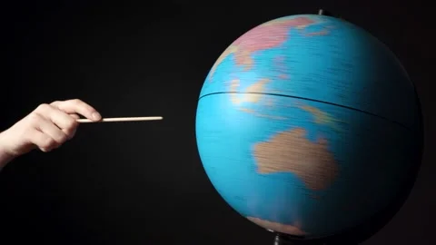 Shooting of rotating around blue globe with hand and pointer Stock Footage 134445212