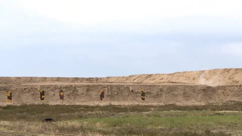 Shooting at a shooting range with a machine gun on growth targets in an open  Stock Footage 140039573