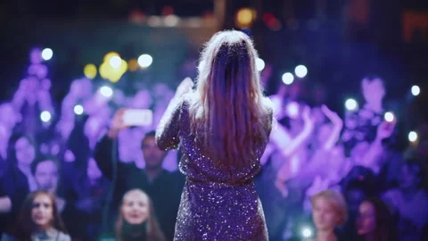 Shooting of the singer from the back on the stage at night in front of pe Video stock 159787525