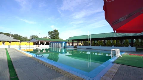 Shooting from a slider in an empty pool in summer in blue water Stock Footage 201590771