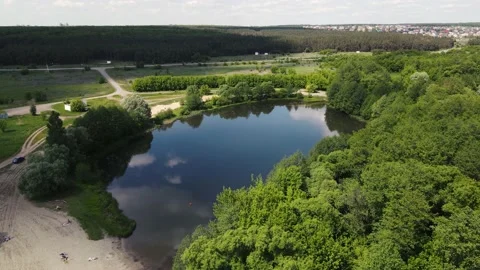 Shooting a small lake in the middle of the field, from a height. aerial shooting Stock Footage 157757879