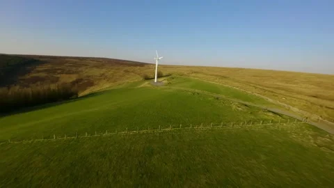 Shooting from sport fpv drone wind turbines on farm in wales in a natural field 스톡 동영상 173217082