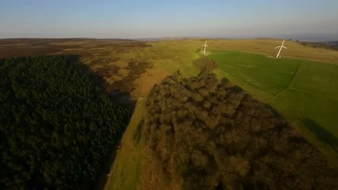 Shooting from sport fpv drone wind turbines on farm in wales in a natural field Stock Footage 173218921