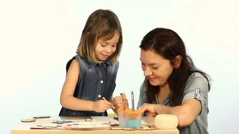 Shooting in the studio on a white background. A child, a funny girl, learns t Stock Footage 83830739