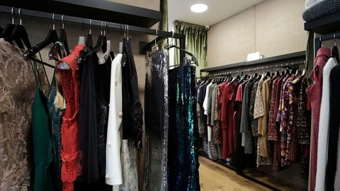 Shooting Three rows of hangers along walls clothes in store Stock Footage 74861885