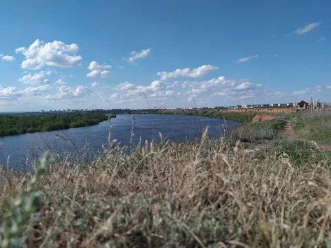 Shooting time lapse from a cliff of the clouds over cityscape and river Stock Footage 131460604