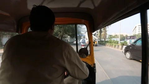 Shooting of the tuk-tuk cab while driving through the streets of Mumbai, India 動画素材 83823637
