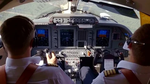 Shooting of two working pilots in a cockpit, flying a plane. Stock Footage 95048093