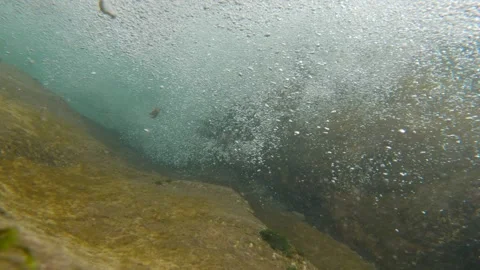 Shooting underwater. The camera is lowered into the seething water. Lots of air Stock Footage 156739267
