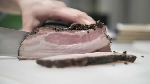 Shooting a video of hands in close-up to cut pork into thin strips. Video stock 171462802