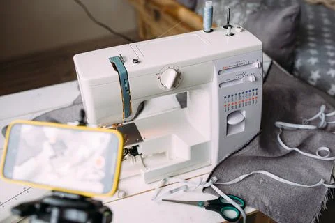 Shooting video of the sewing process, workshop on clothing design on smartphone Stock Photos