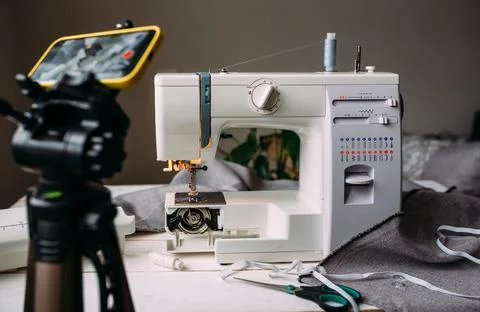 Shooting video of the sewing process, workshop on clothing design on smartphone Stock Photos