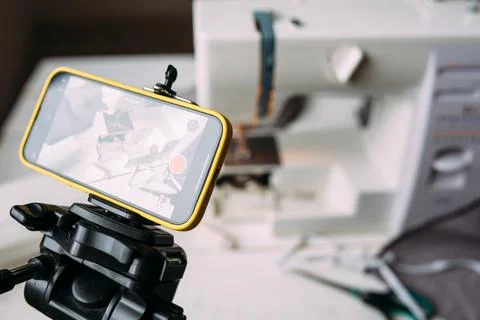 Shooting video of the sewing process, workshop on clothing design on smartphone Stock Photos