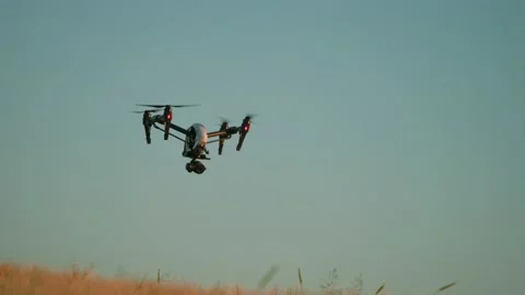 Shooting of white drone on background of blue sky. View of flying quadcopter Stock Footage 207766254